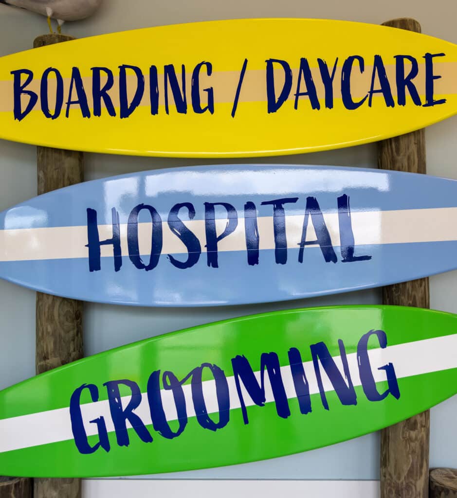 DogBeach sign made out of surfboards promoting boarding ,daycare, vet clinic and grooming services